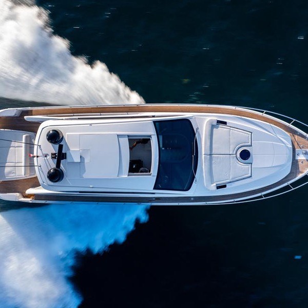 Motor yacht from above on blue water